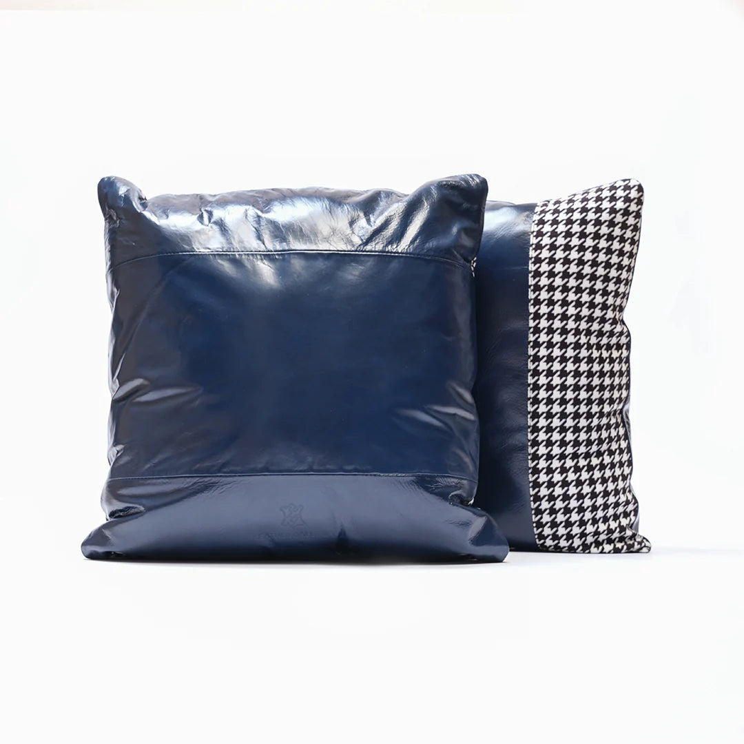 Two pillows, one blue and one with a houndstooth pattern, on a white background.