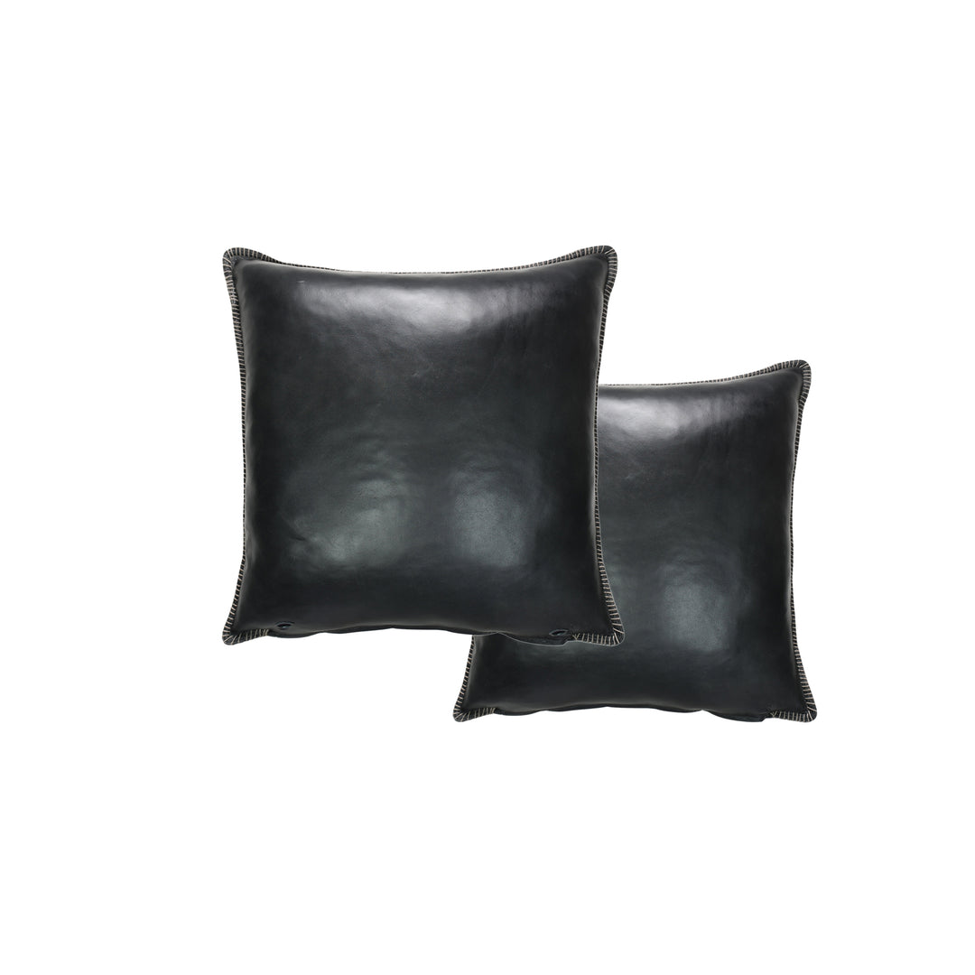 Two black leather pillows on a white background