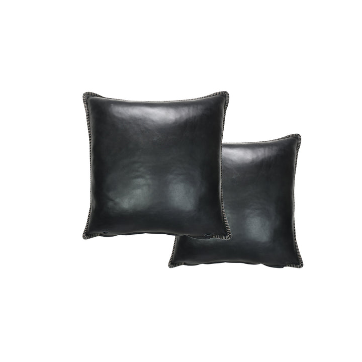 Two black leather pillows on a white background