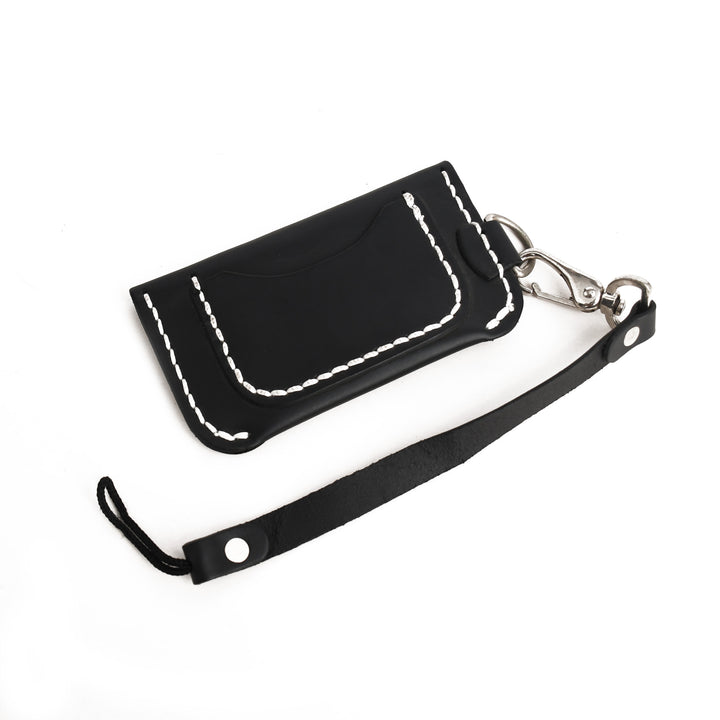 Black leather wallet with white stitching on a white background