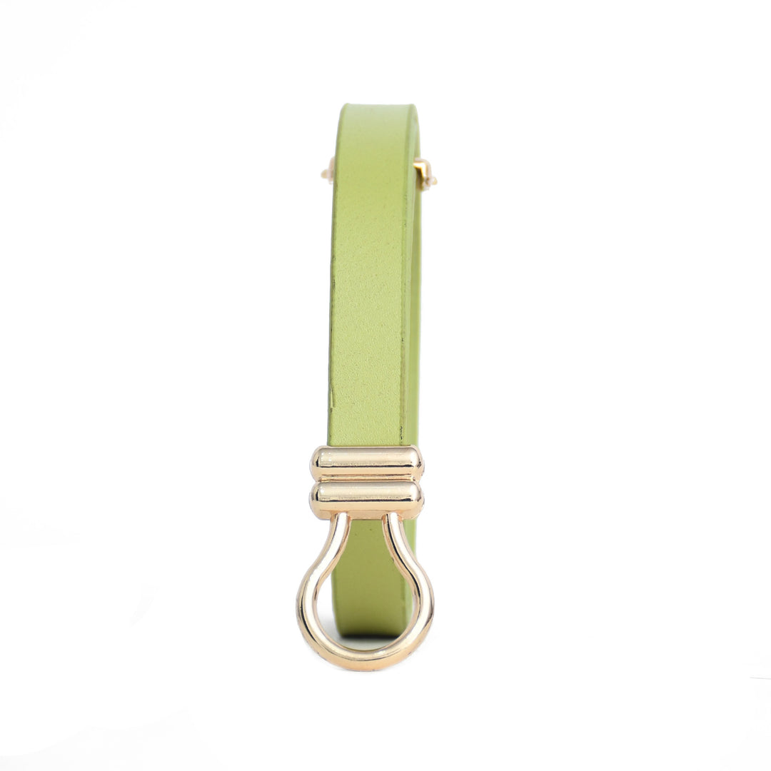 Light green ladies belt with golden buckle on a white background