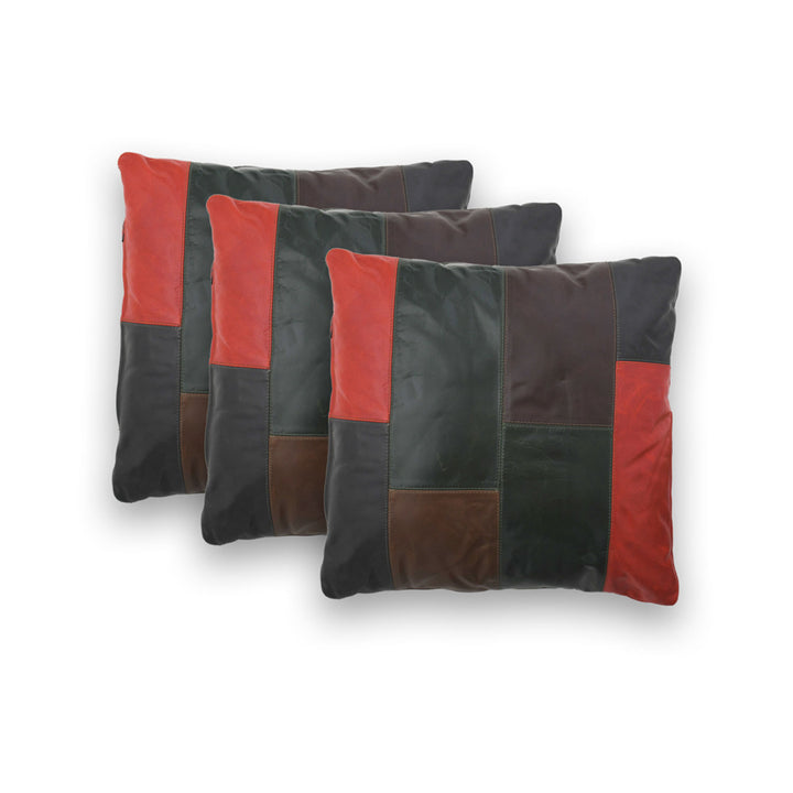 Three Patchwork pillow with red and black leather squares on a white background