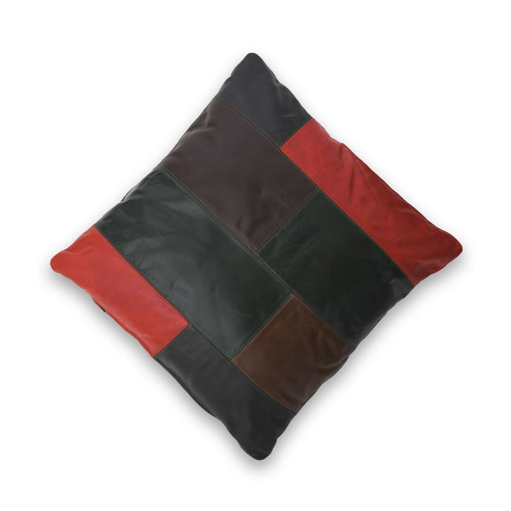 Patchwork pillow with red and black leather squares on a white background