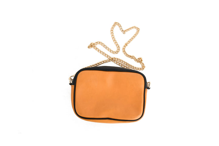 Orange handbag with a gold chain on a white background