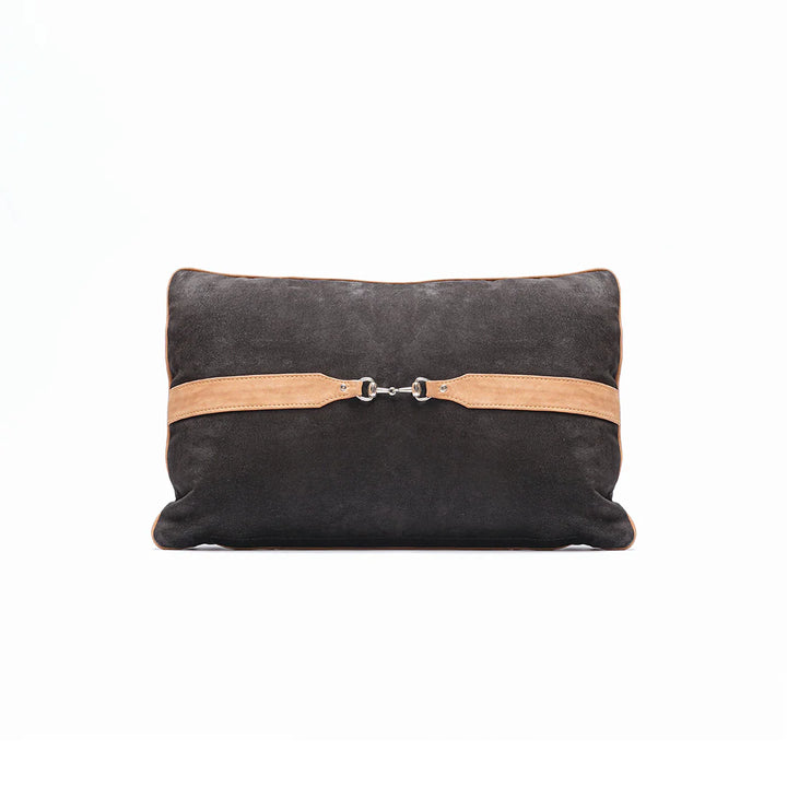 Black pillow with a tan leather strap on a white background
