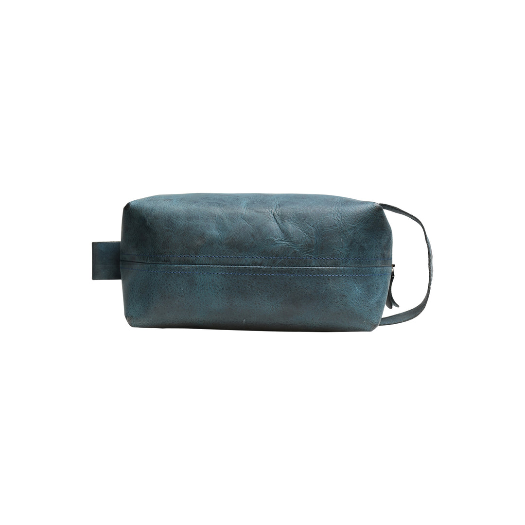 Blue leather toiletry bag on a white background