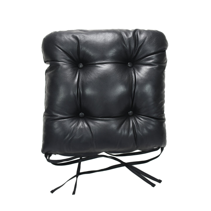 Black leather chair cushion with buttons on a white background