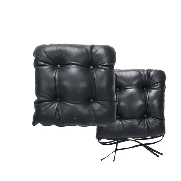 Two black leather chair cushions on a white background