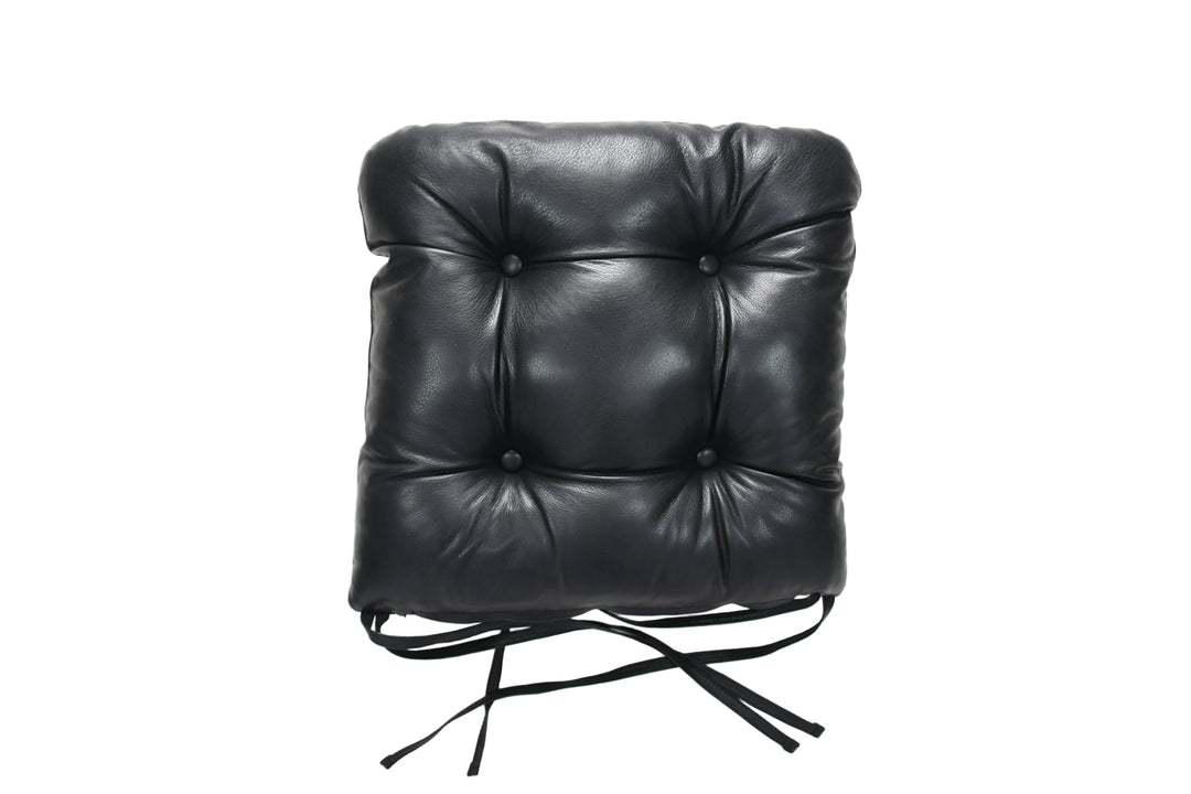 Black leather chair cushion on a white background