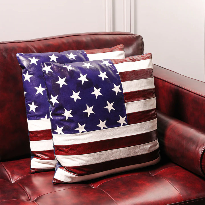 American flag-themed pillows on a red leather couch