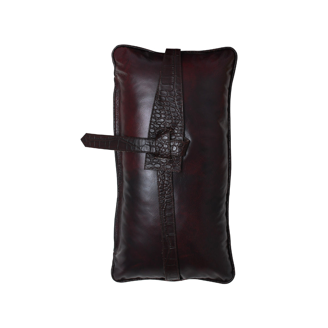 Brown leather cushion with a strap on a white background