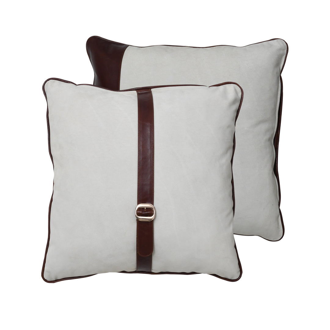 Two white pillows with brown straps and buckles on a white background