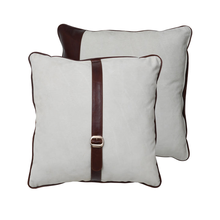 Two white pillows with brown straps and buckles on a white background