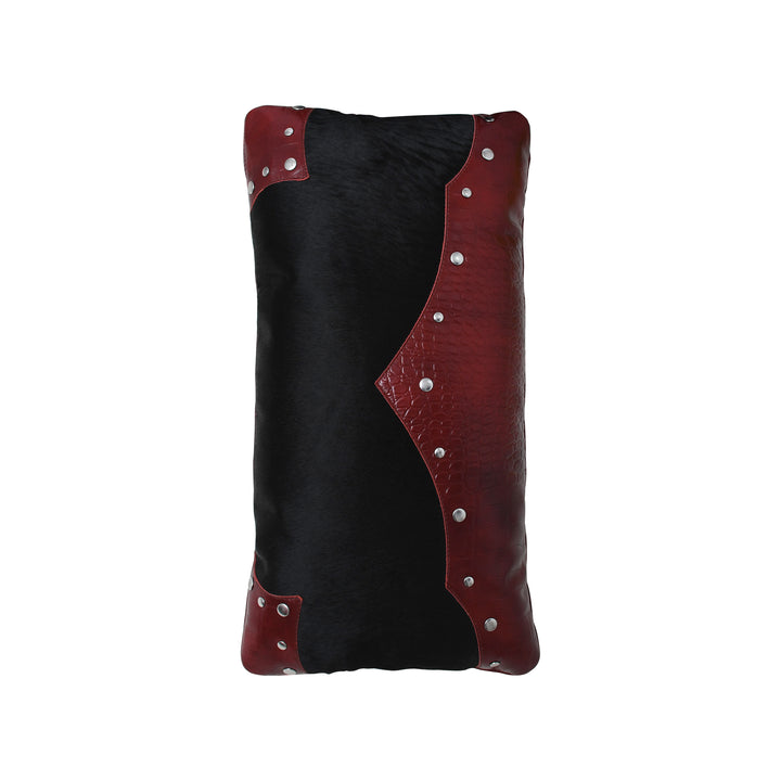Black and red leather cushion with silver studs on a white background