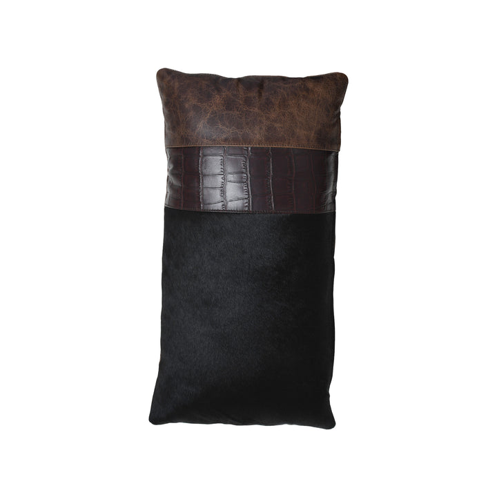 Black pillow with brown leather trim on a white background