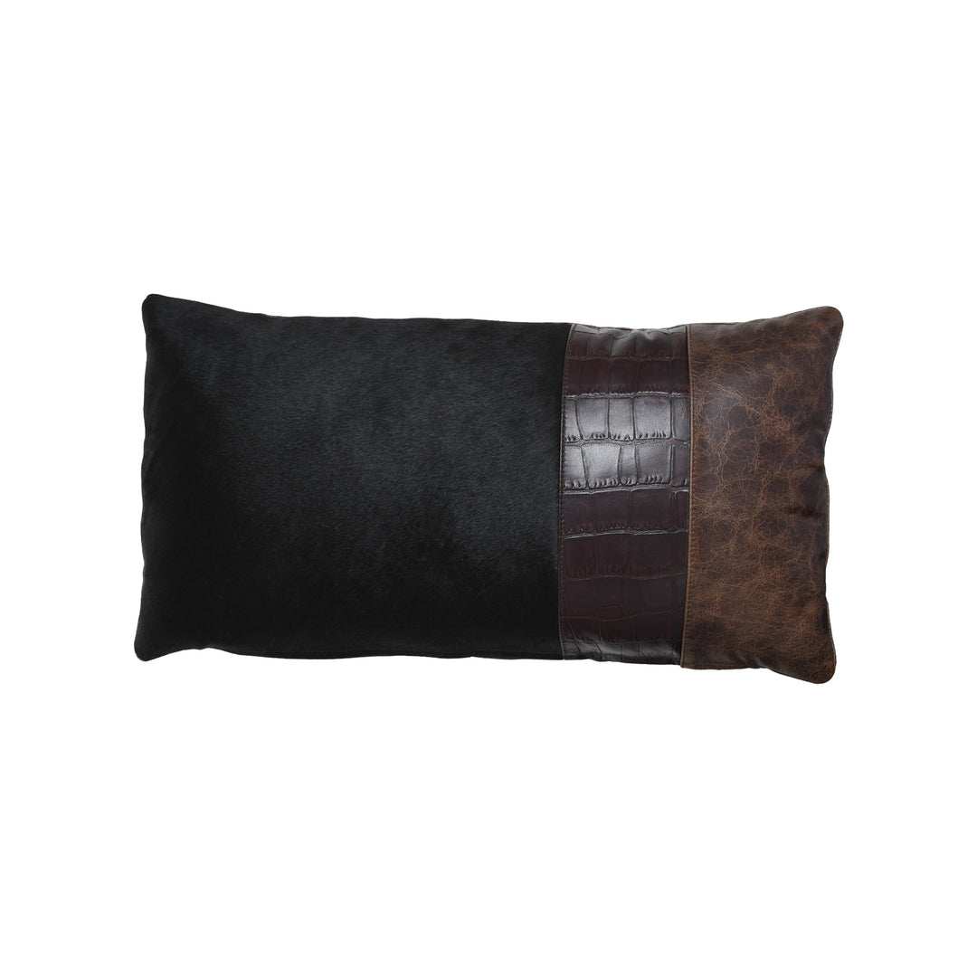 Black and brown leather pillow with crocodile texture on a white background