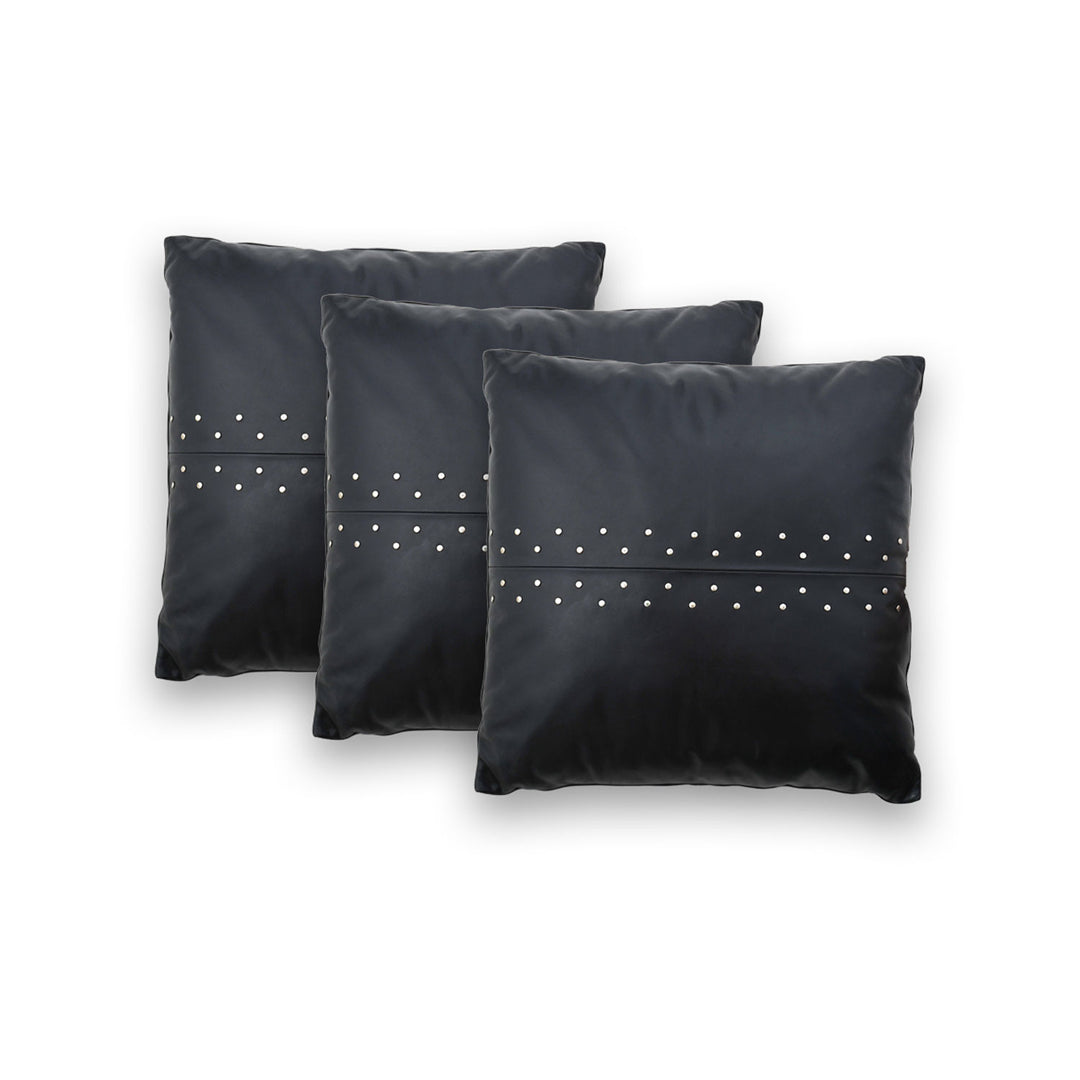 Three Black pillows with silver studs on a white background