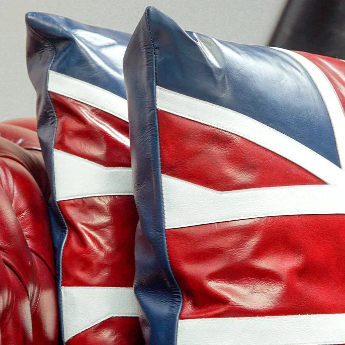 Leather pillow with Union Jack design on a red leather couch.
