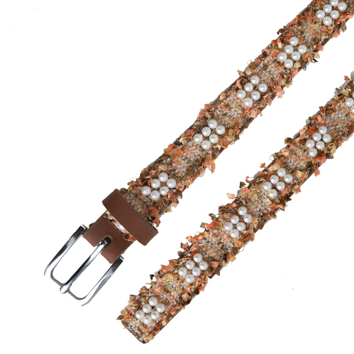Belt with floral pattern and pearl-like stones on a white background