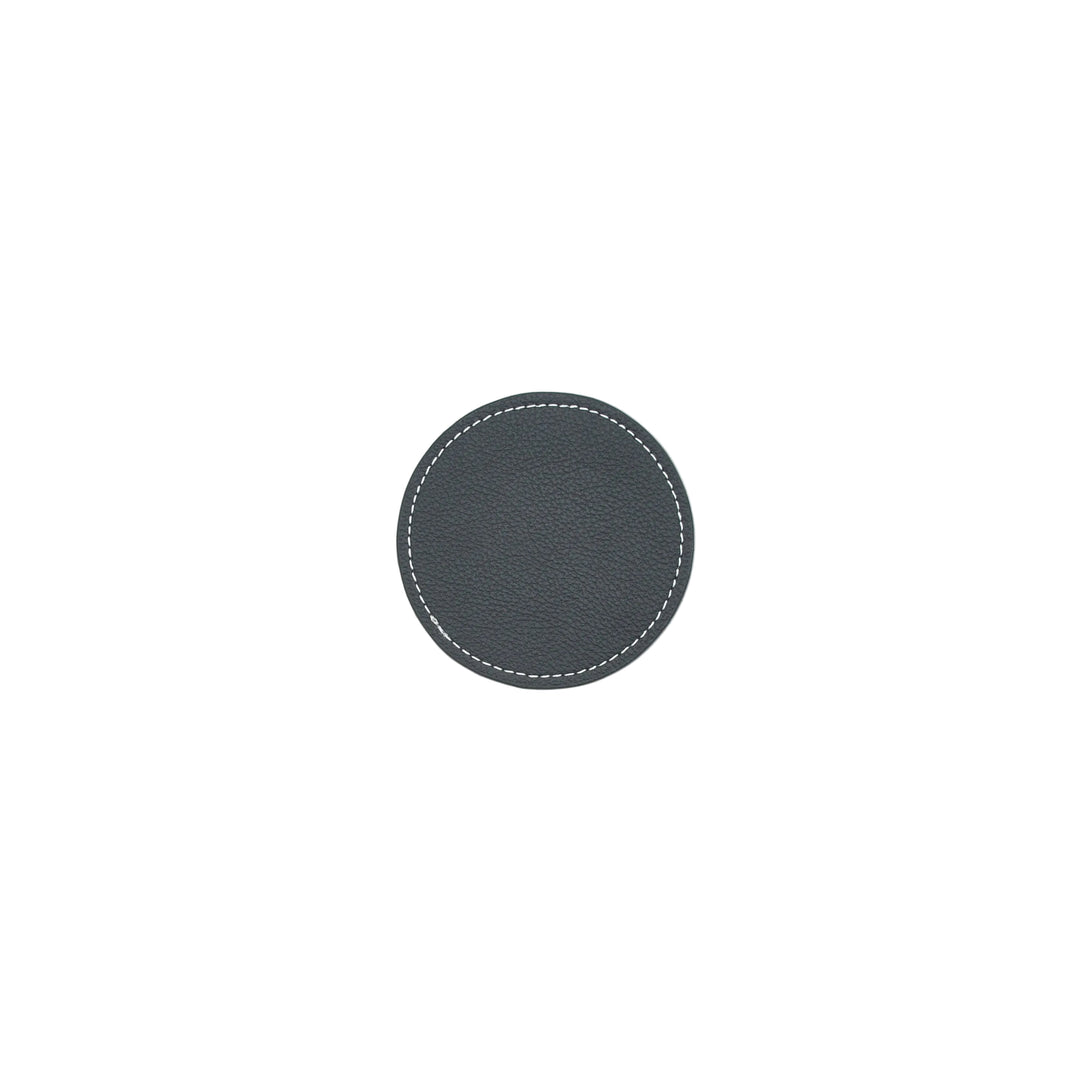 Round black leather coaster with white stitching on a white background