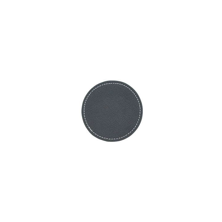Round black leather coaster with white stitching on a white background