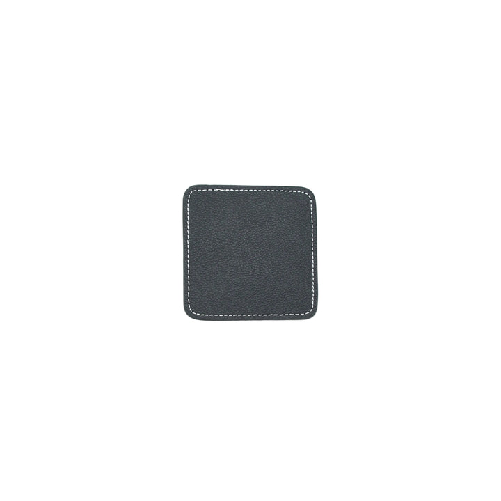 Black square coaster with white stitching on a white background