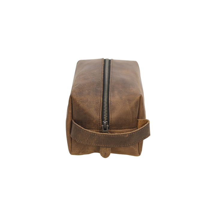 Brown leather toiletry bag with a zipper on a white background