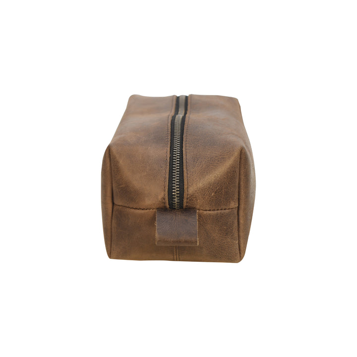 Brown leather toiletry bag with a zipper on a white background