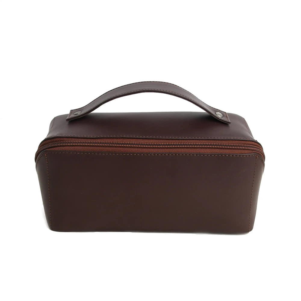 Brown leather toiletry bag with a handle on a white background