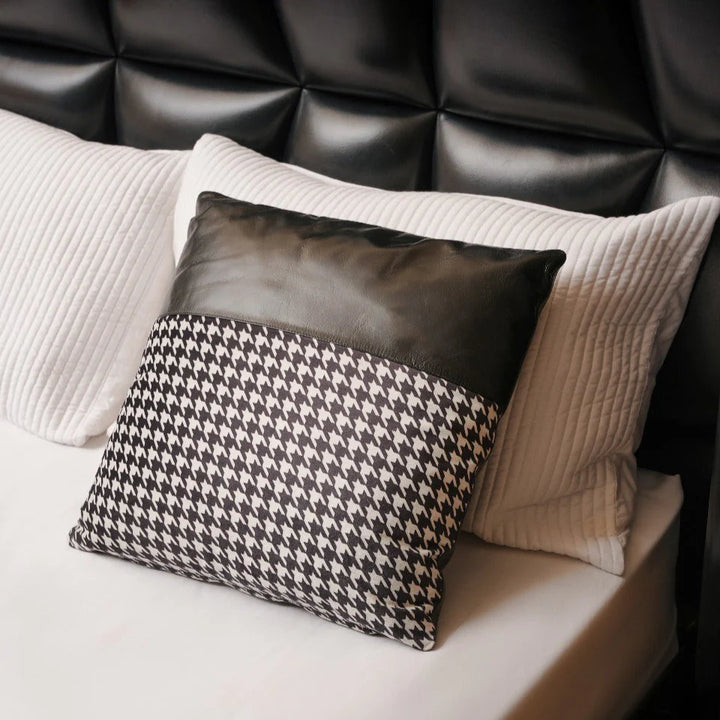 Decorative pillows on a bed with a textured headboard