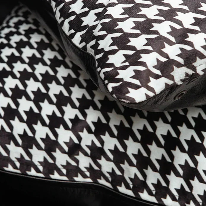 Close-up of black and white houndstooth pattern cushion