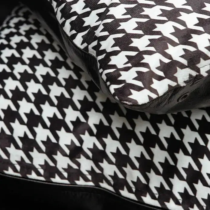 Close-up of black and white houndstooth pattern cushion