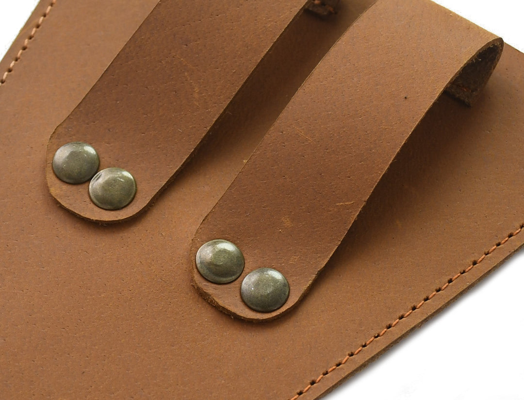 Close-up of a brown leather organizer with metal studs on a white background