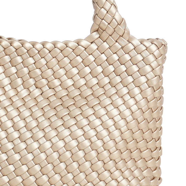 Close-up of a beige woven handbag on a white background