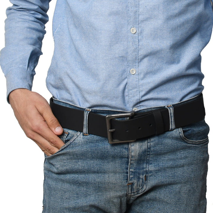 Light blue button-up shirt with a logo and dark jeans on a white background

