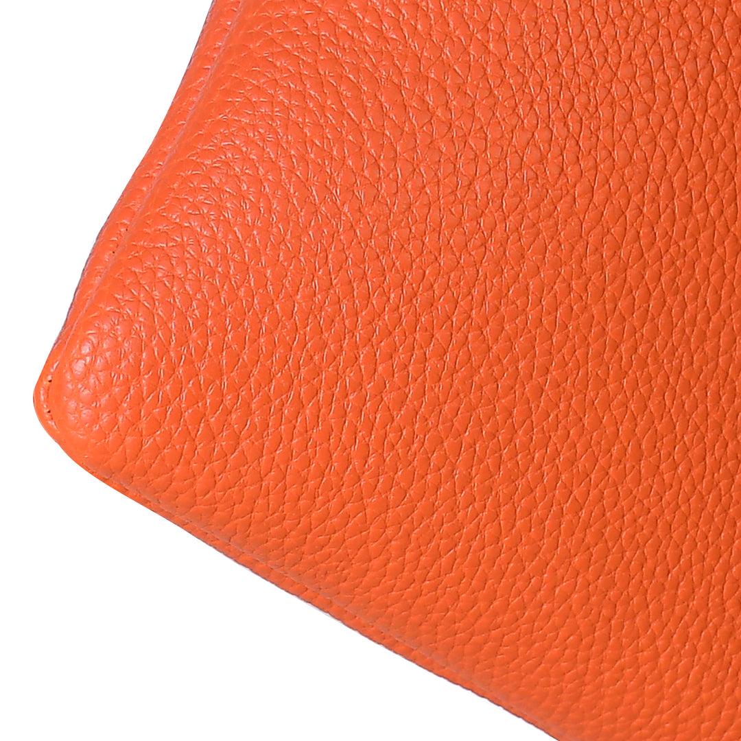 Close-up of an orange leather surface with a textured pattern
