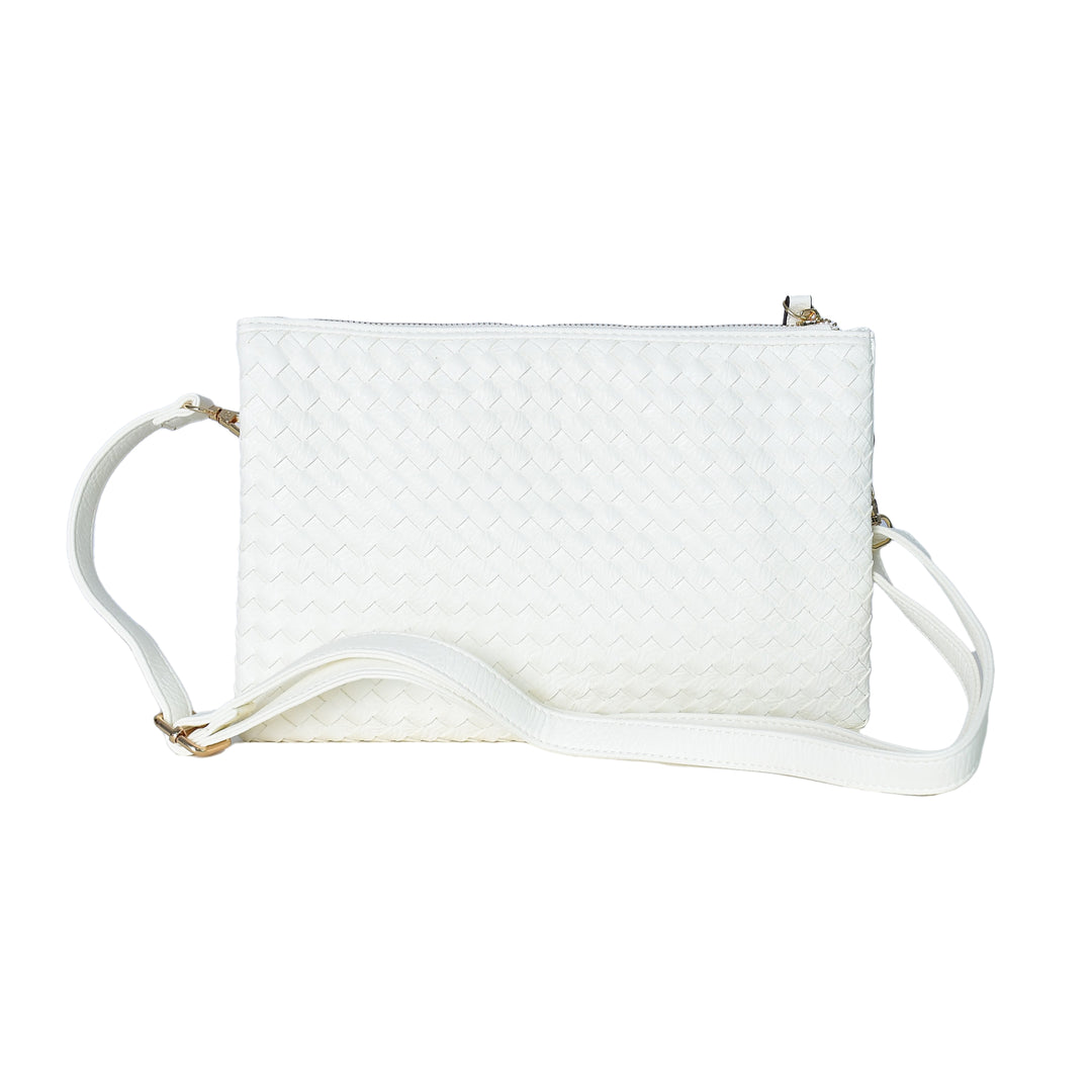 White quilted handbag with a strap on a white background