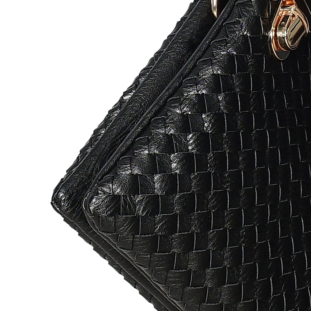 Close-up of a black woven handbag with a gold clasp on a white background