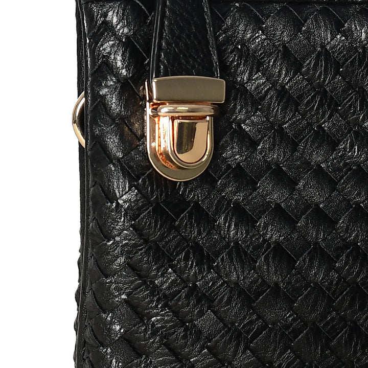 Close-up of a black woven handbag with a gold clasp on a white background