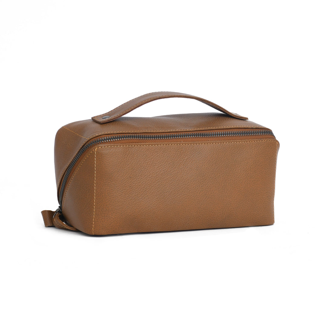 Brown leather toiletry bag with a handle on a white background