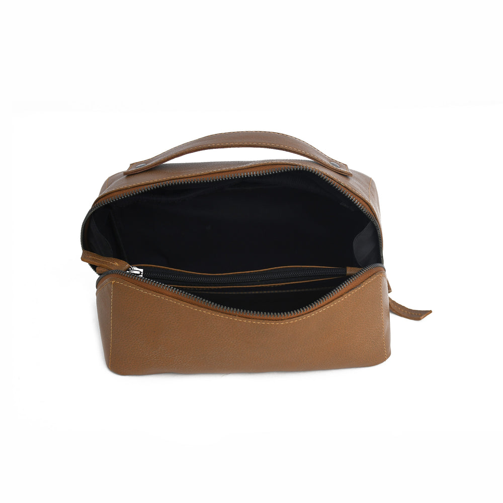 Brown leather toiletry bag with open compartment on a white background