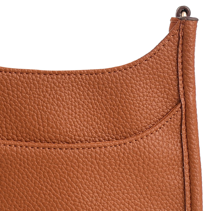 Close-up of a brown leather bag with a visible stitching detail on a white background