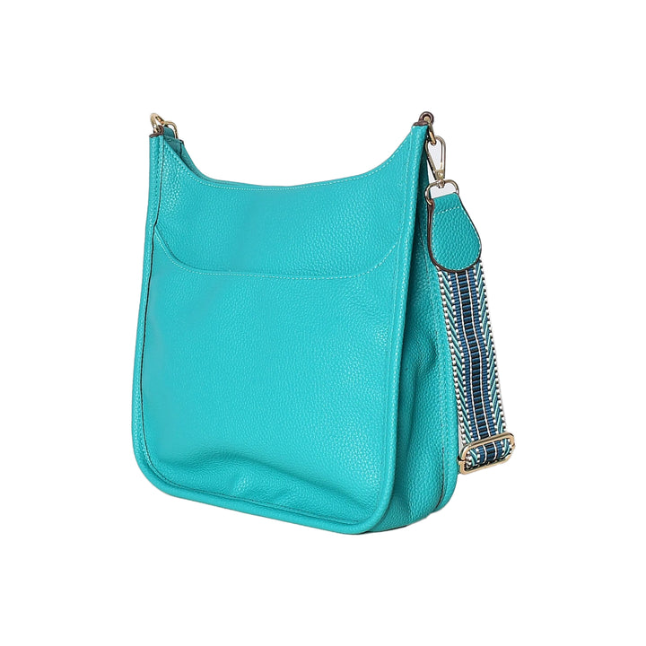 Turquoise handbag with a decorative strap on a white background