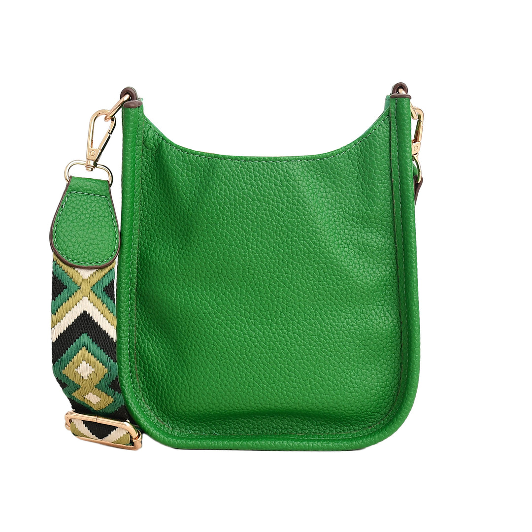 Green leather handbag with a patterned strap on a white background