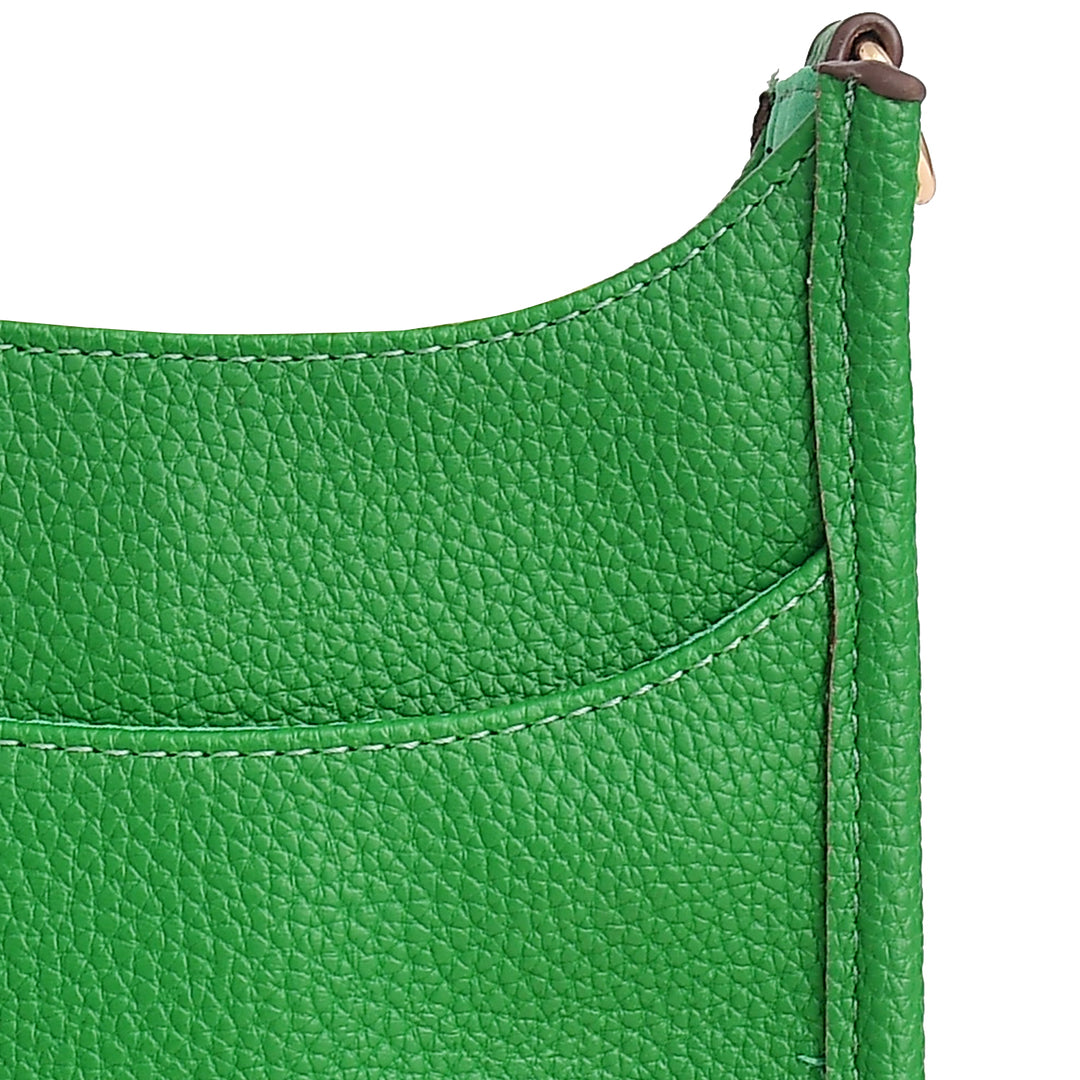 Close-up of a green leather bag with a zipper on a white background