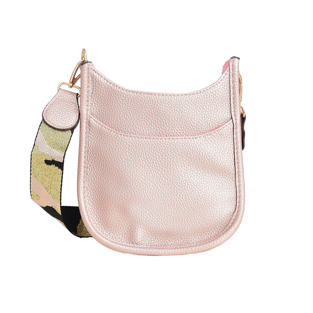 Pink leather crossbody bag with a colorful strap on a white background