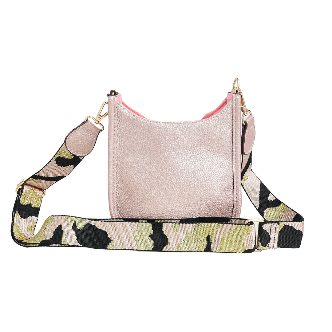 Pink handbag with a camouflage-patterned strap on a white background