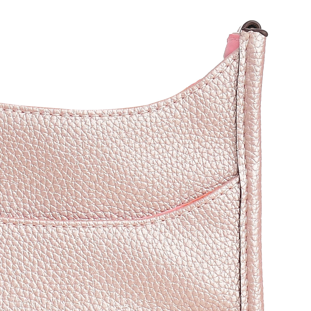 Close-up of a pink leather product with visible stitching on a white background