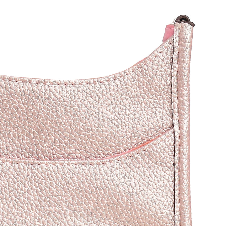 Close-up of a pink leather product with visible stitching on a white background