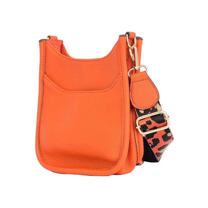Orange crossbody bag with a patterned strap on a white background